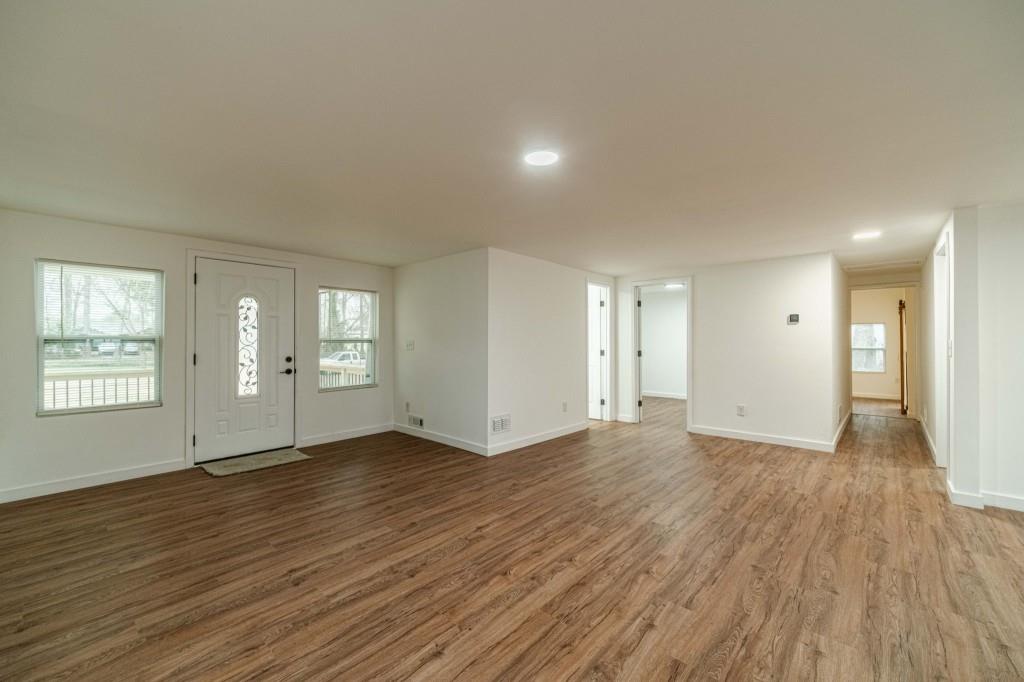 3617 Bob White Lane Southwest Loganville, GA 30052 - Photo 6 of 48 an empty room with wooden floor and windows