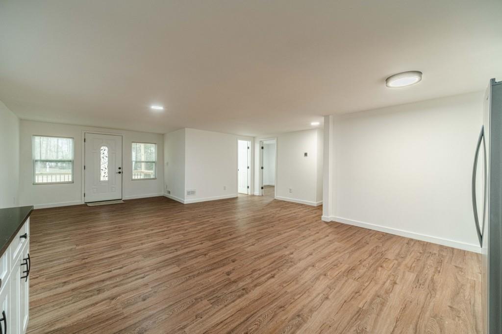 3617 Bob White Lane Southwest Loganville, GA 30052 - Photo 7 of 48 an empty room with wooden floor and window