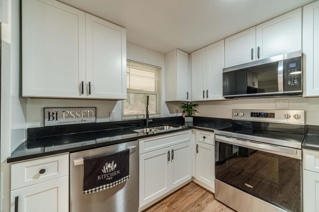 3617 Bob White Lane Southwest Loganville, GA 30052 - Photo 10 of 48 a kitchen with a sink stove and microwave