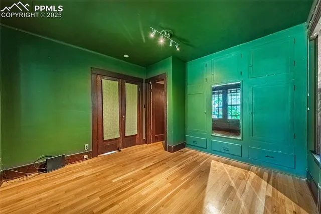 a bedroom with a bed and a large window