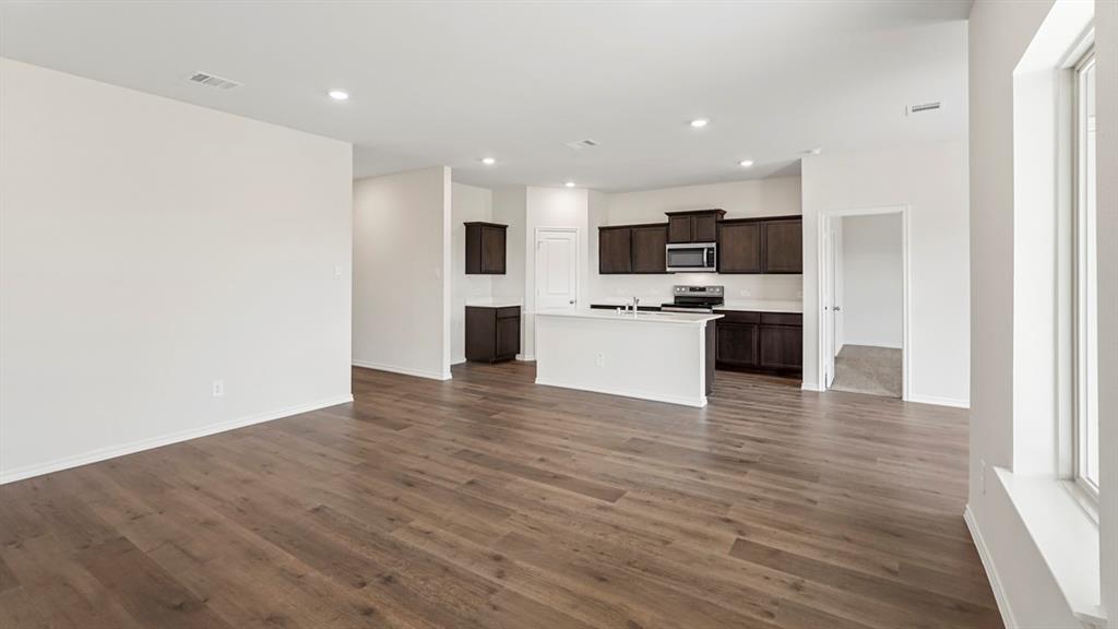 1969 Freeman Street Tyler, TX 75704 - Photo 7 of 30 Spacious open-concept area featuring wood-finish flooring, recessed lighting, and a kitchen island