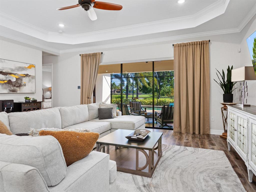 16532 Hillside Circle Lakewood Ranch, FL 34202 - Photo 11 of 67 a living room with furniture and a large window