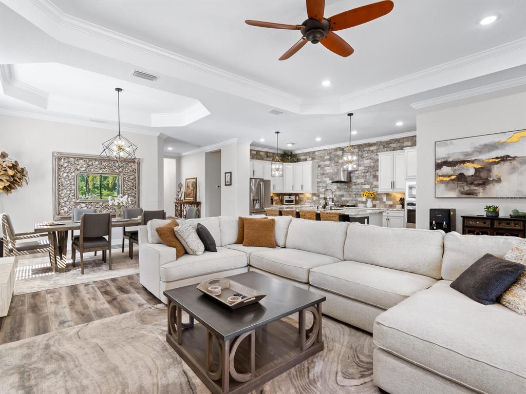 16532 Hillside Circle Lakewood Ranch, FL 34202 - Photo 13 of 67 a living room with furniture kitchen view and a chandelier