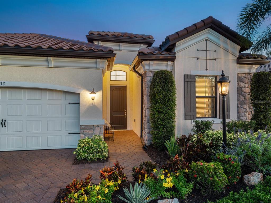 16532 Hillside Circle Lakewood Ranch, FL 34202 - Photo 4 of 67 a view of a house with a flower garden