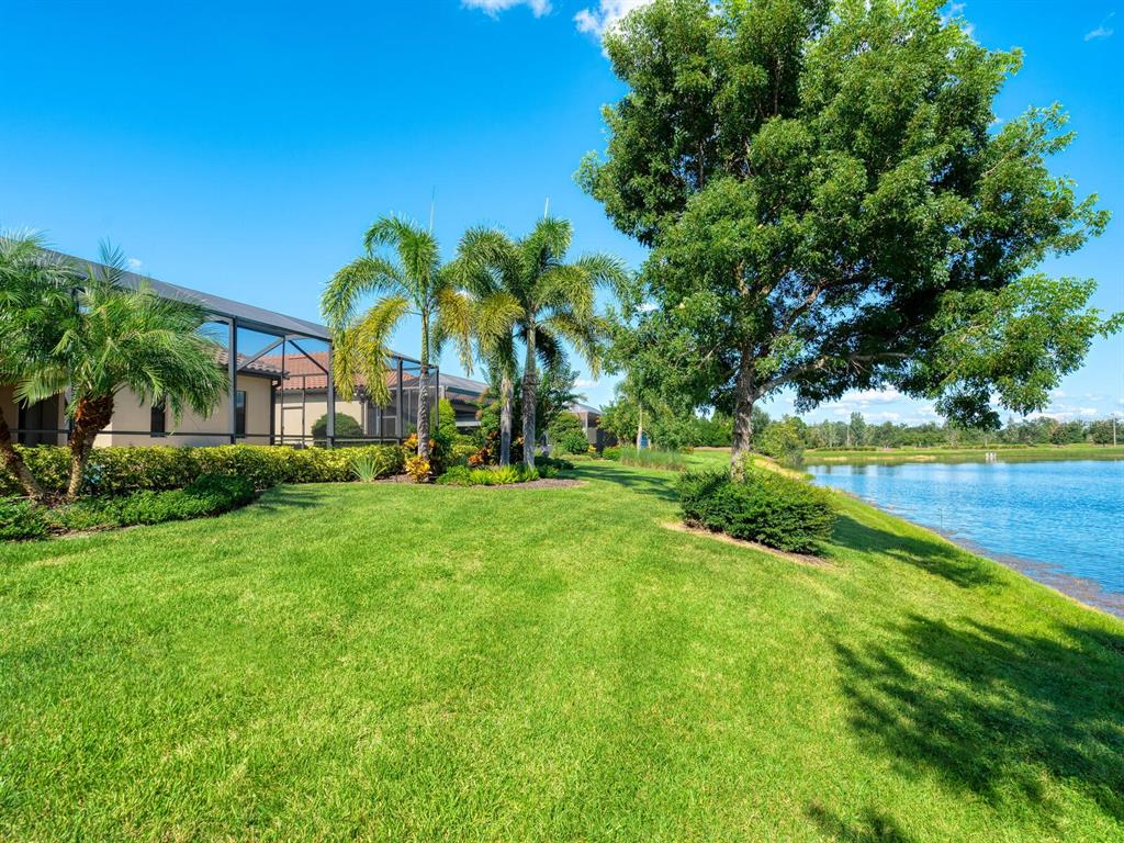 16532 Hillside Circle Lakewood Ranch, FL 34202 - Photo 46 of 67 a view of a swimming pool with a garden and plants