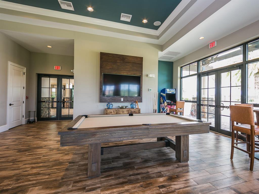 16532 Hillside Circle Lakewood Ranch, FL 34202 - Photo 54 of 67 a room with wooden floor table and sofas