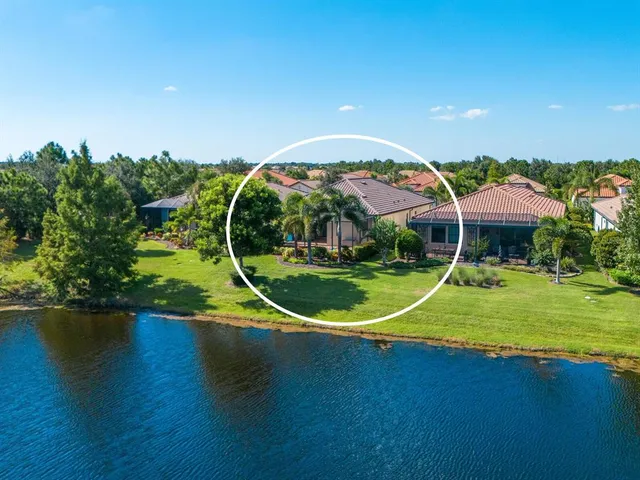 an aerial view of a house with a yard and potted plants