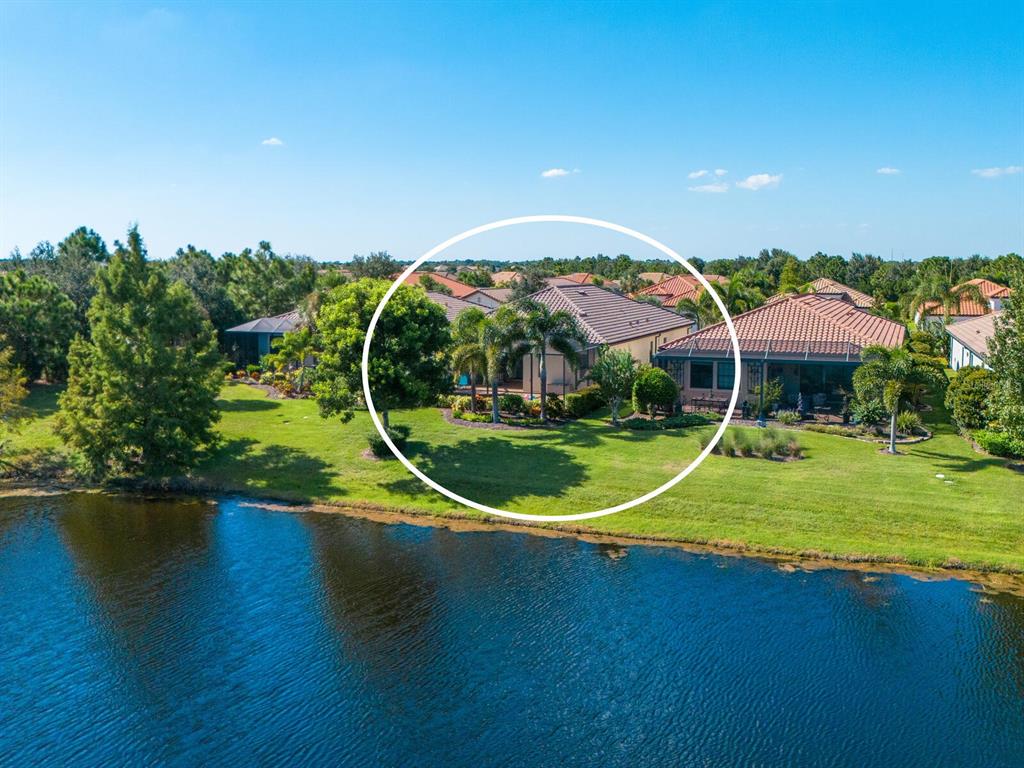 16532 Hillside Circle Lakewood Ranch, FL 34202 - Photo 6 of 67 an aerial view of a house with swimming pool patio and lake view