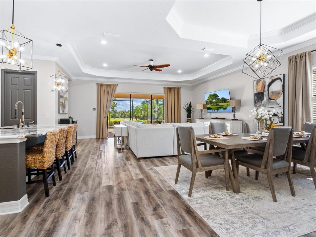 16532 Hillside Circle Lakewood Ranch, FL 34202 - Photo 9 of 67 a view of a dining room with furniture and a chandelier