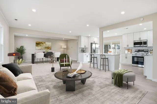 a living room with furniture and a view of kitchen