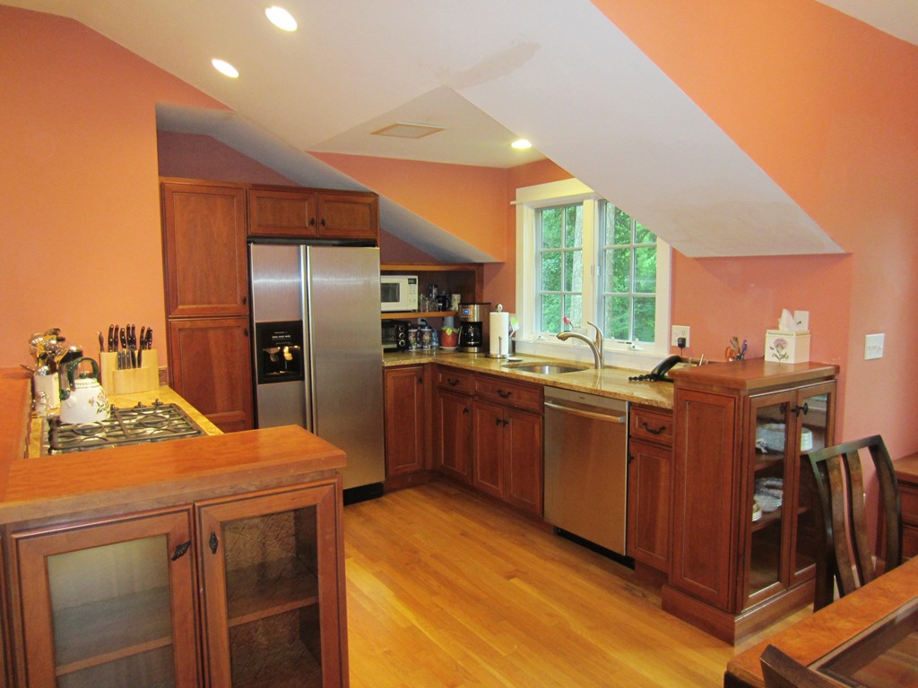 9 West Riding Street Wellesley, MA 02482 - Photo 8 of 16 a kitchen with kitchen island granite countertop a sink cabinets and stainless steel appliances
