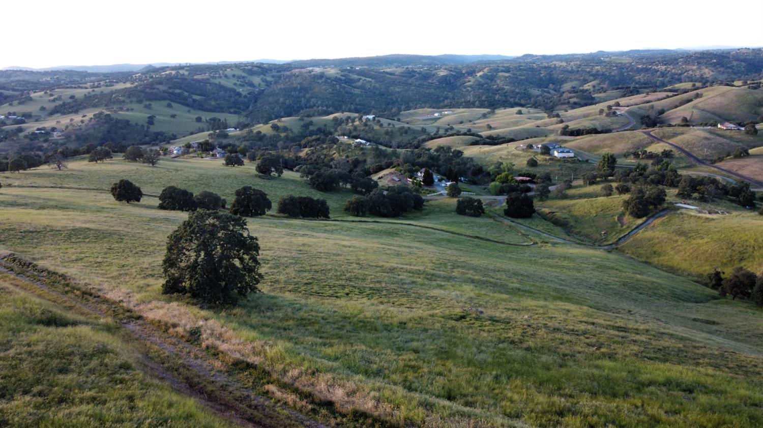 9830 New Chicago Road Drytown, CA 95699 - Photo 19 of 51 a view of a grassy area with mountains and a houses