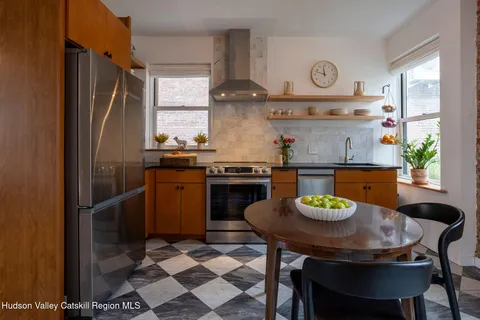 a kitchen with a sink a stove and chairs
