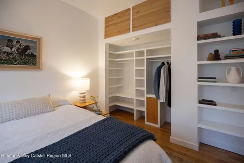 a bedroom with a bed and a walk in closet