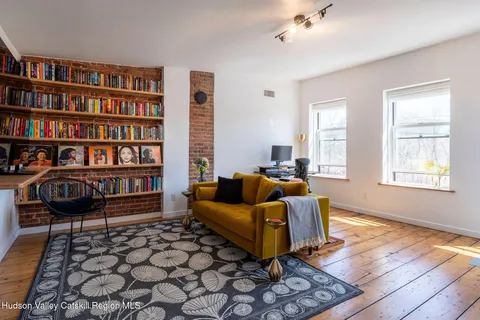 a living room with furniture and a book shelf