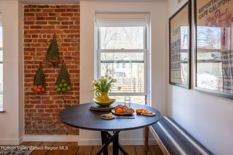 a view of a dining room with furniture and window