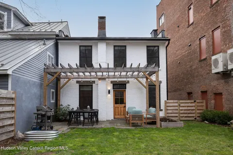 a view of a house with a yard porch and sitting area