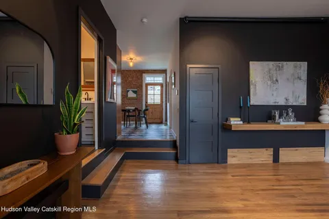 a view of a hallway and wooden floor