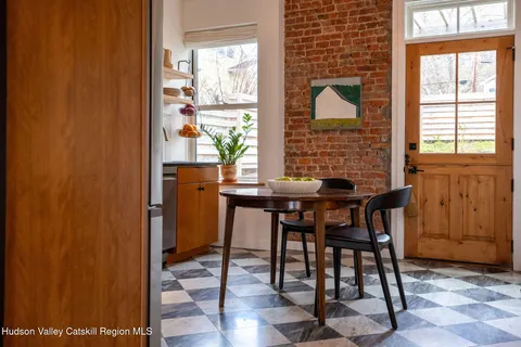 a view of a dining room with furniture and window