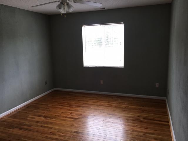 1650 Dickerson Road Goodview, VA 24095 - Photo 24 of 30 a view of an empty room with wooden floor and a window