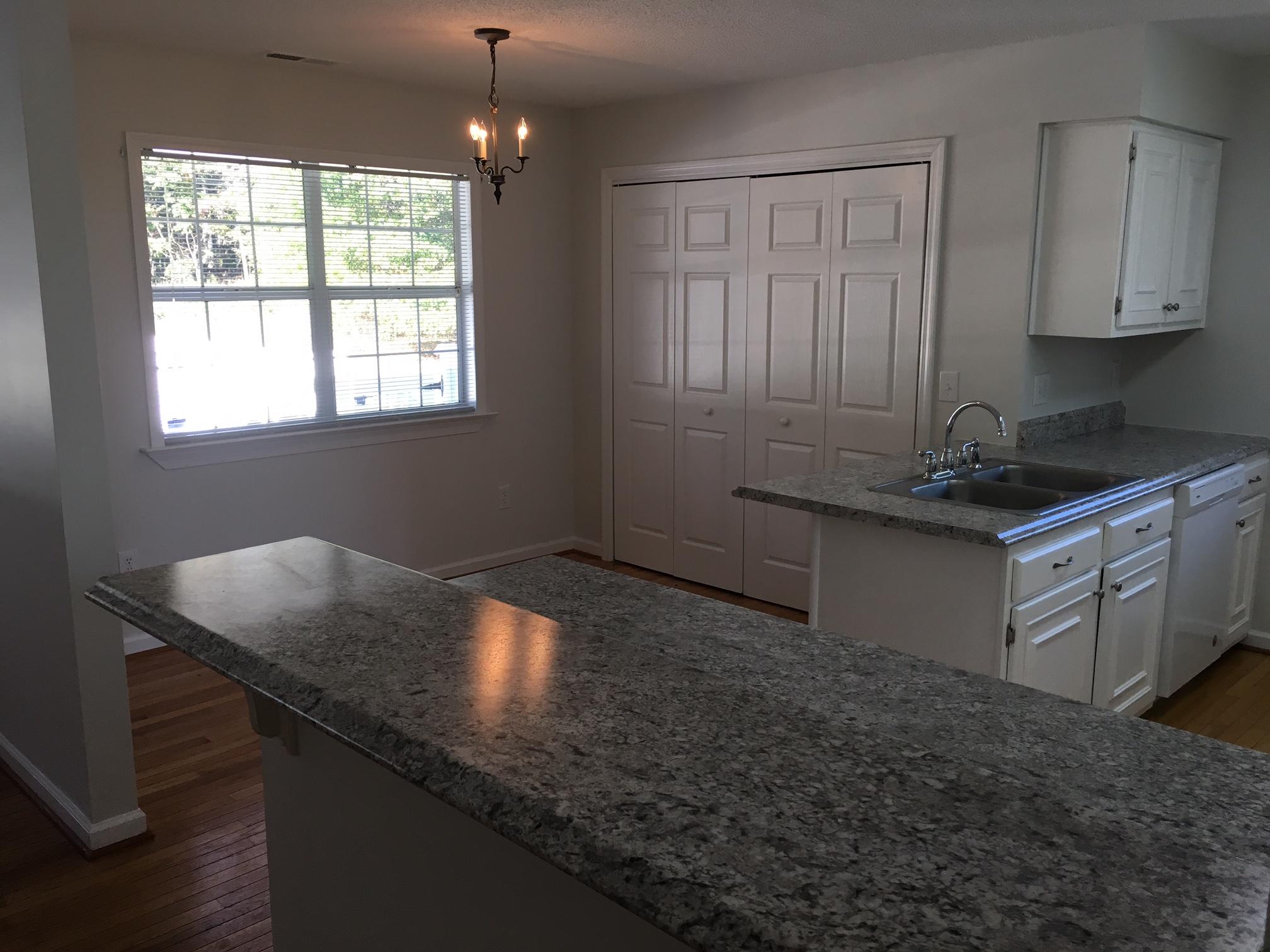 1650 Dickerson Road Goodview, VA 24095 - Photo 6 of 30 a kitchen with granite countertop a sink window and cabinets