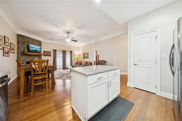 a open kitchen with stainless steel appliances granite countertop a stove and a refrigerator