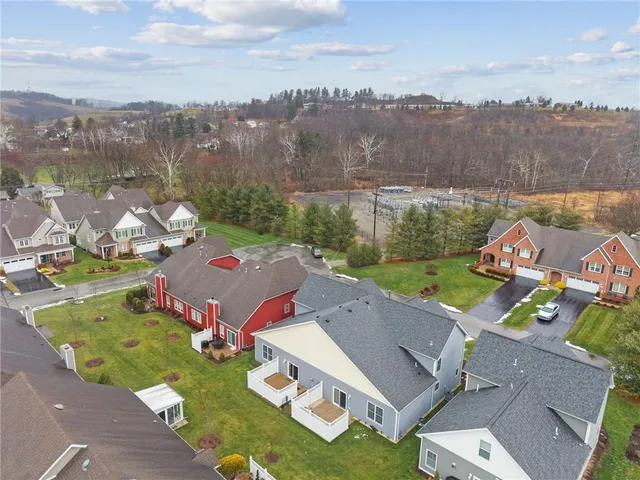 an aerial view of a house with garden space and outdoor seating