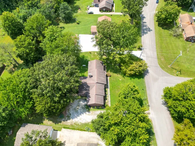 an aerial view of a house with a yard and garden