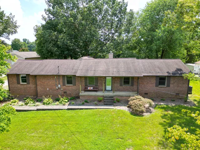 a front view of a house with a garden and patio