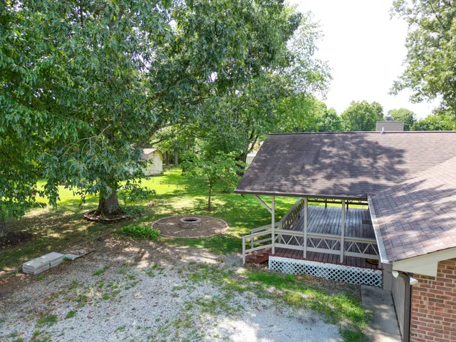 a view of a backyard with chairs