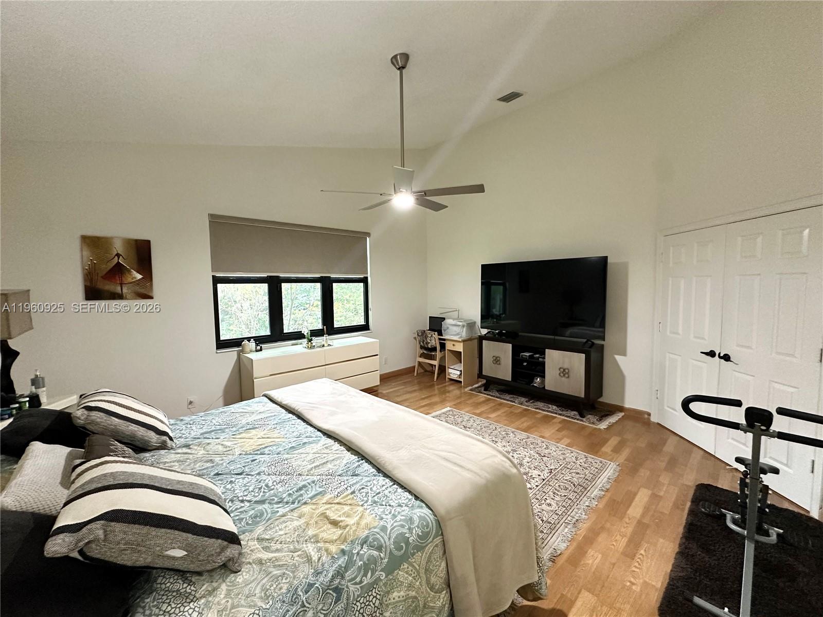 5790 Coach House Circle, Unit E Boca Raton, FL 33486 - Photo 31 of 65 a bedroom with bed tv and a mirror
