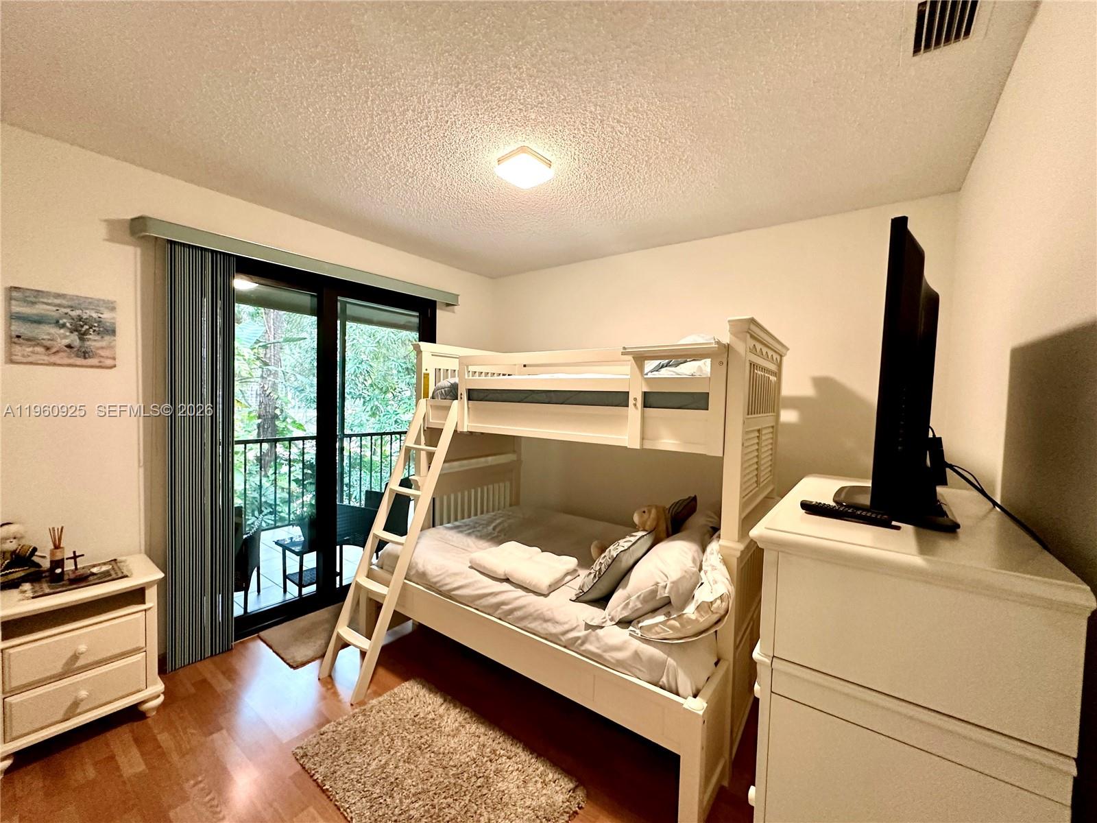 5790 Coach House Circle, Unit E Boca Raton, FL 33486 - Photo 40 of 65 a bed room with a bed and a window