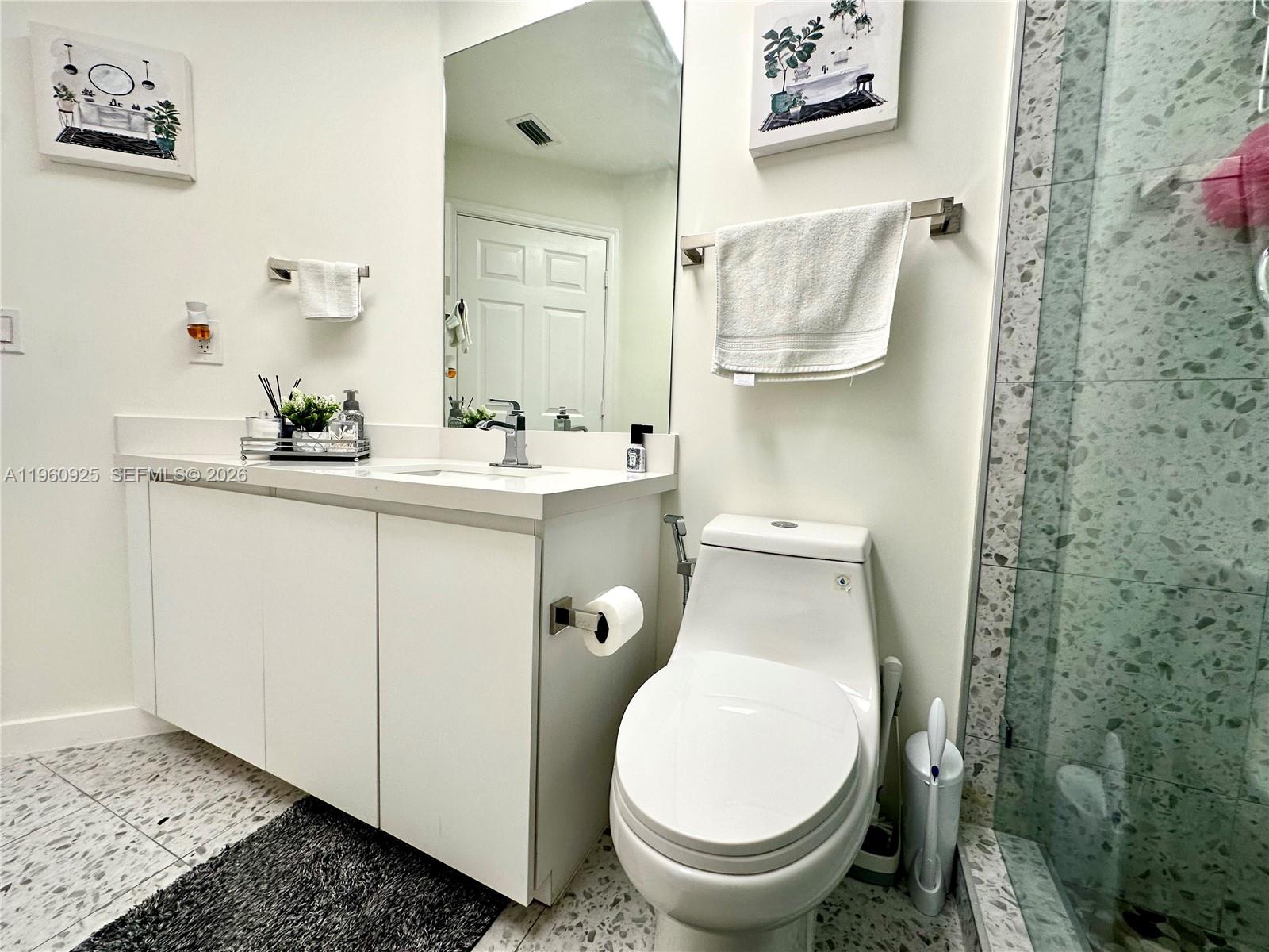 5790 Coach House Circle, Unit E Boca Raton, FL 33486 - Photo 47 of 65 a bathroom with a toilet and a sink