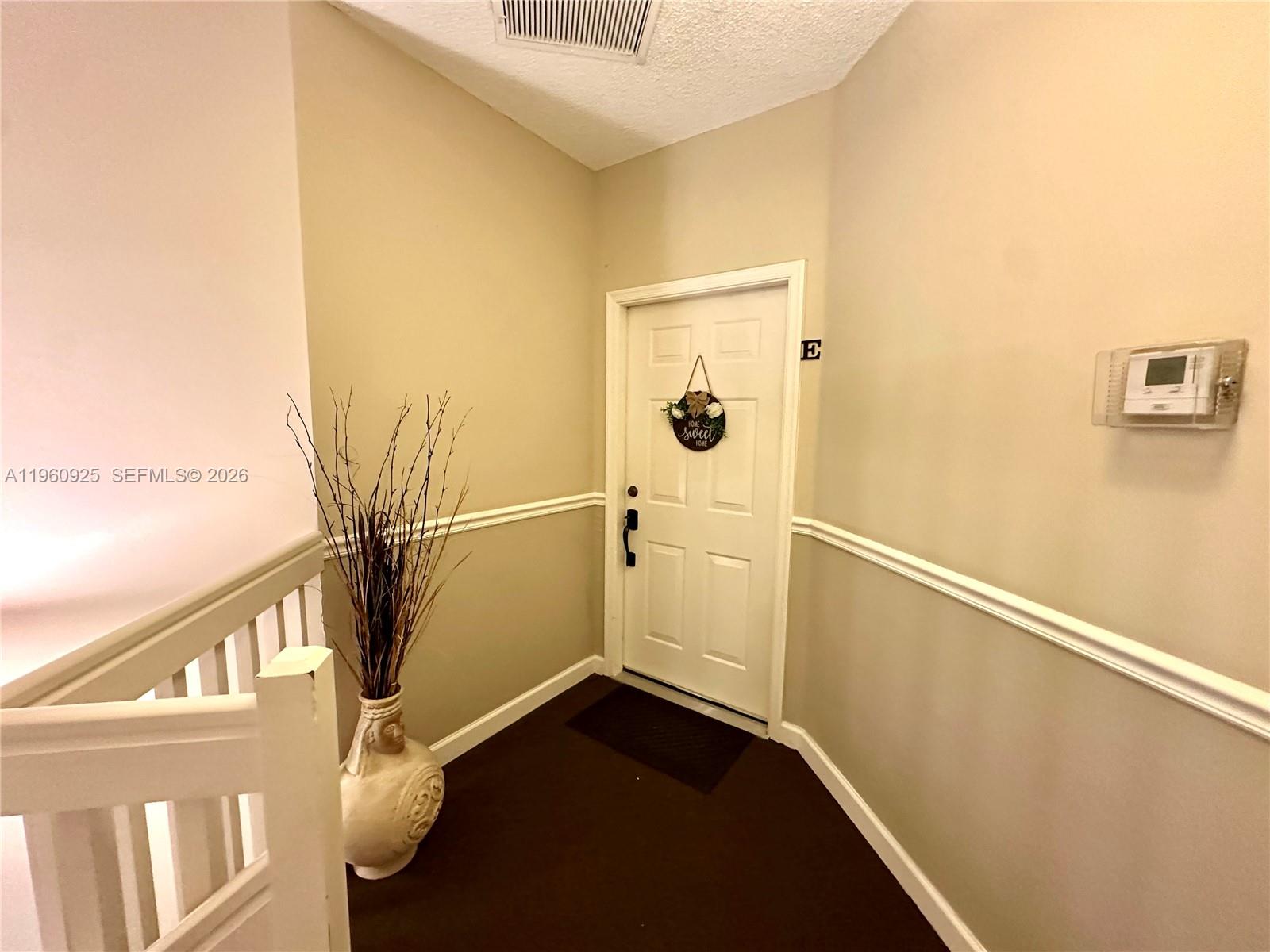 5790 Coach House Circle, Unit E Boca Raton, FL 33486 - Photo 6 of 65 a view of a hallway with wooden floor and staircase