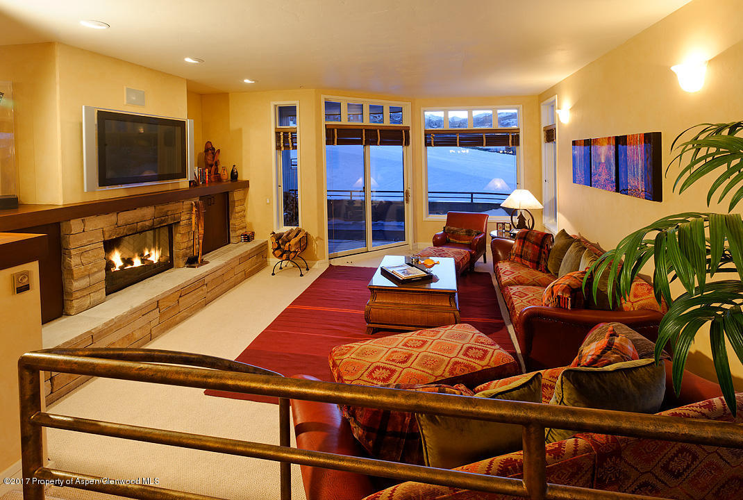 a living room with furniture flat screen tv and a fireplace