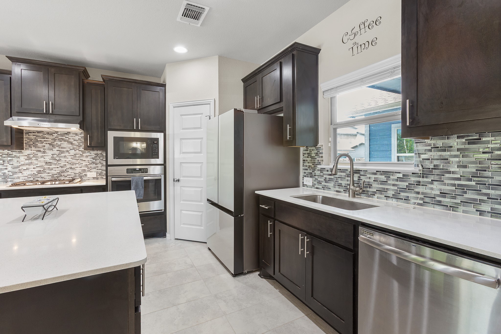 8709 Slater Drive Austin, TX 78747 - Photo 5 of 36 a kitchen with stainless steel appliances a sink and a refrigerator