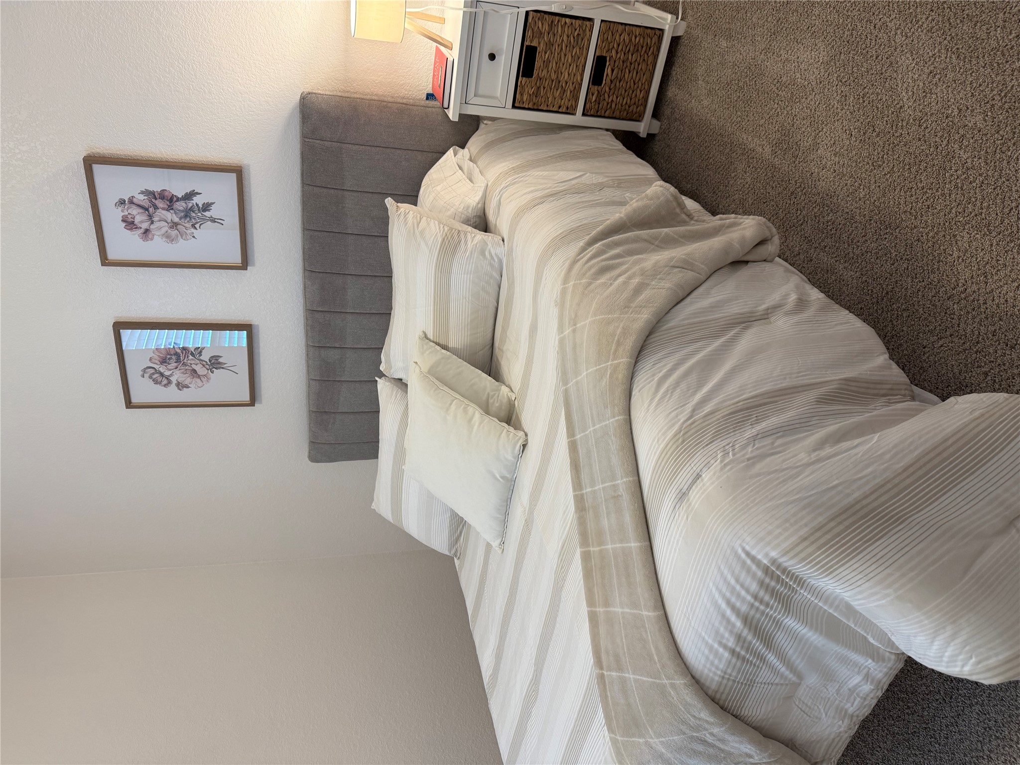 14907 Retha Pass Austin, TX 78725 - Photo 22 of 22 Plush carpeted floors extend through this serene bedroom, featuring a comfortable headboard and thoughtful bedside table.