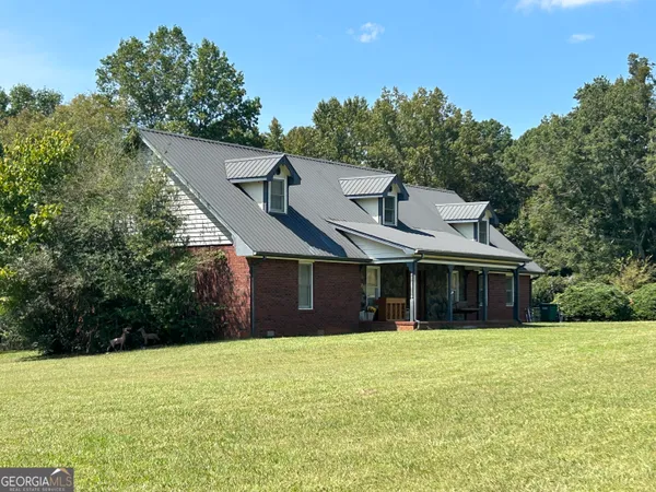 a front view of house with yard and green space
