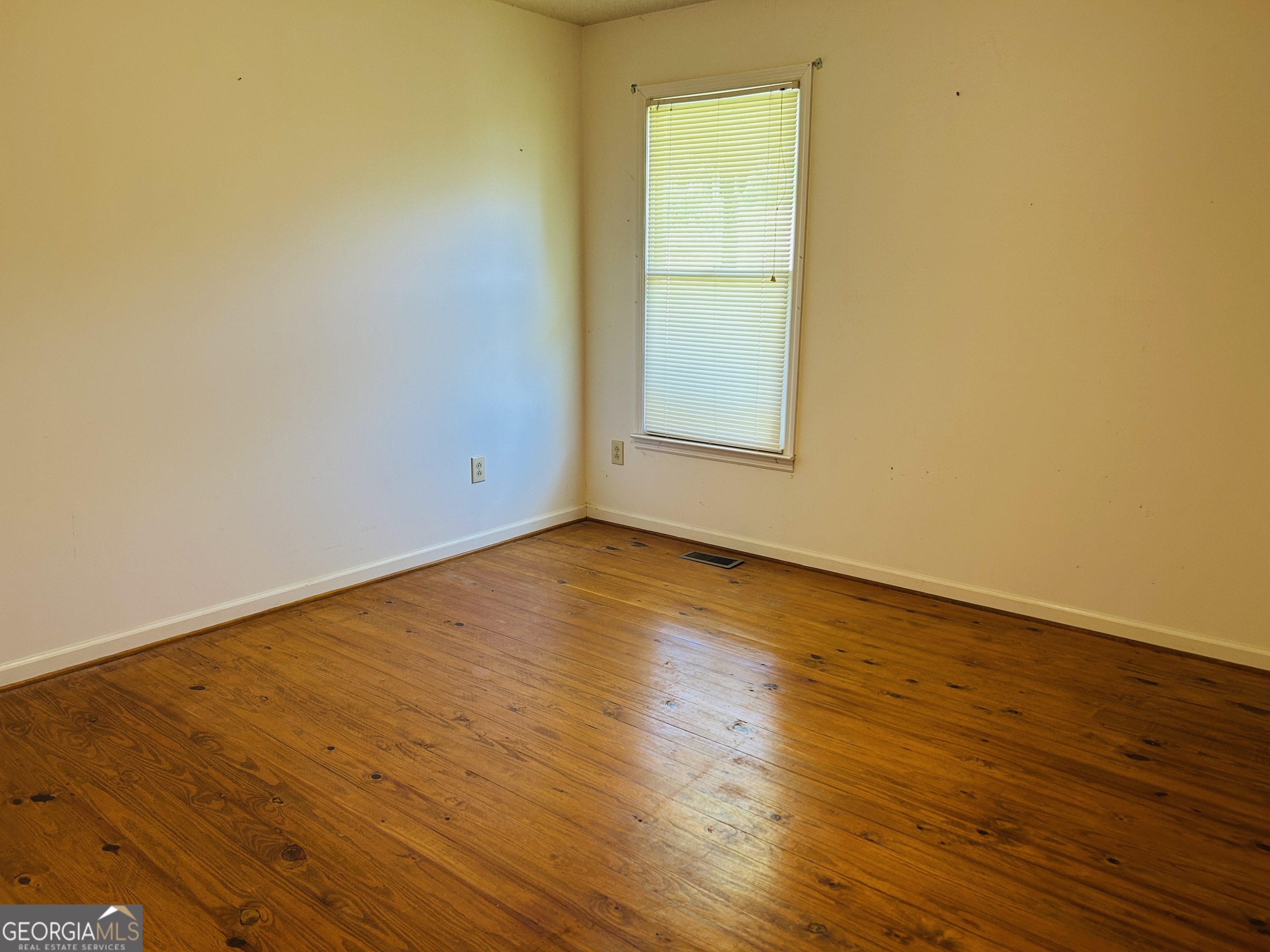 817 Yonah Homer Road Homer, GA 30547 - Photo 17 of 43 an empty room with wooden floor and windows
