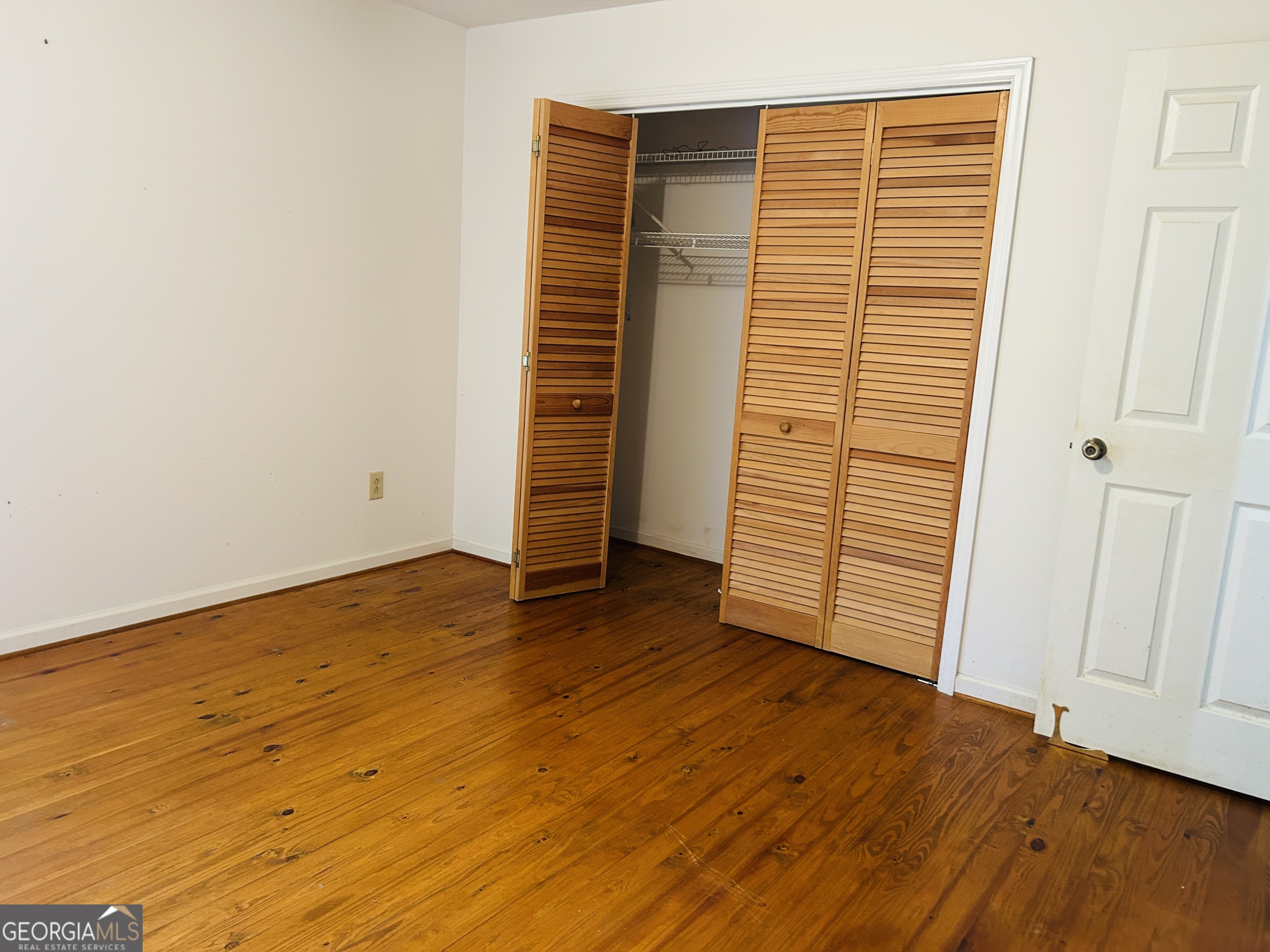 817 Yonah Homer Road Homer, GA 30547 - Photo 18 of 43 an empty room with wooden floor and windows