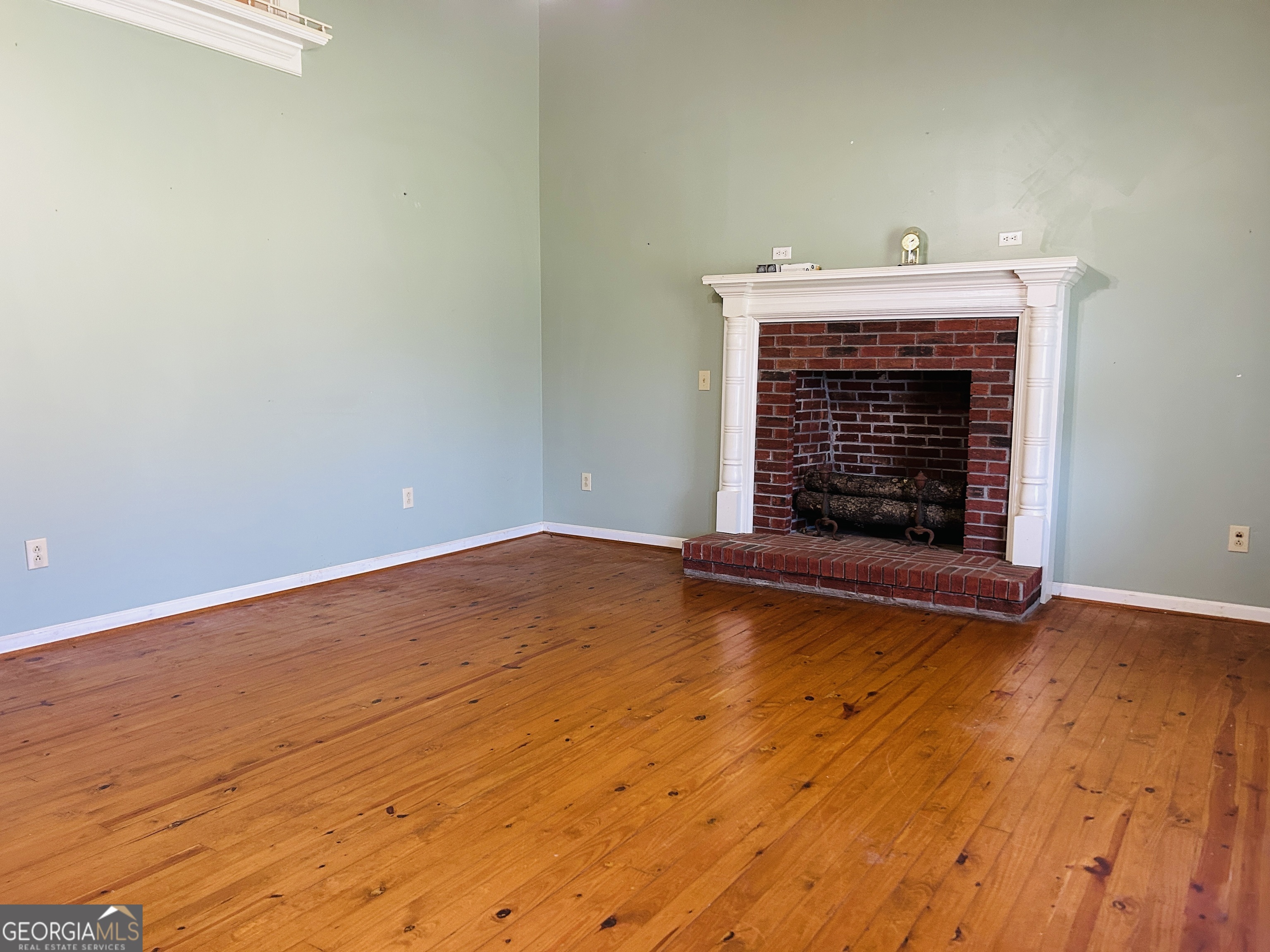 817 Yonah Homer Road Homer, GA 30547 - Photo 9 of 43 a view of empty room with wooden floor and fireplace