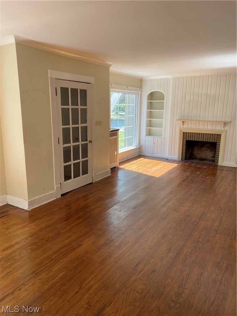 1730 Wood Road Cleveland Heights, OH 44121 - Photo 3 of 34 Hardwood floored living room with built in features and a fireplace