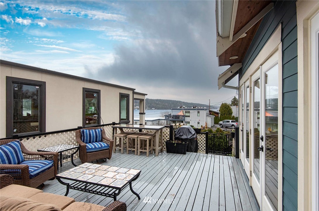 803 North 33rd Street Renton, WA 98056 - Photo 15 of 40 a view of a patio with couches chairs potted plants and wooden floor