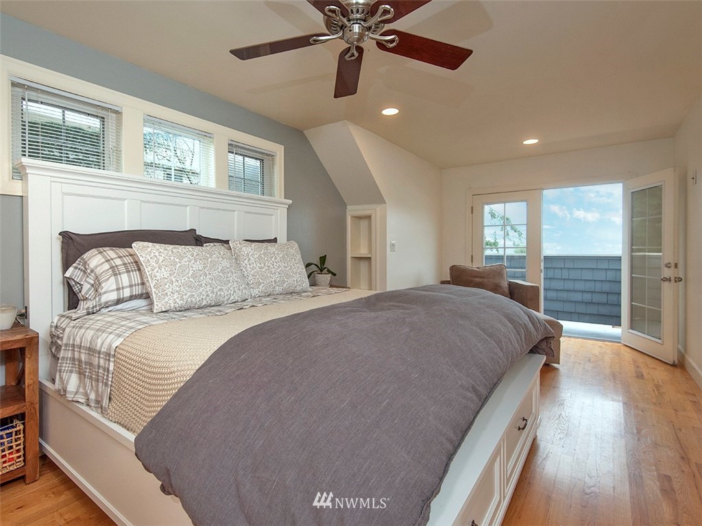 803 North 33rd Street Renton, WA 98056 - Photo 17 of 40 a bedroom with a large bed and a chandelier