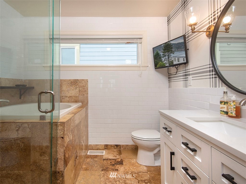 803 North 33rd Street Renton, WA 98056 - Photo 20 of 40 a bathroom with a granite countertop sink a toilet and a mirror