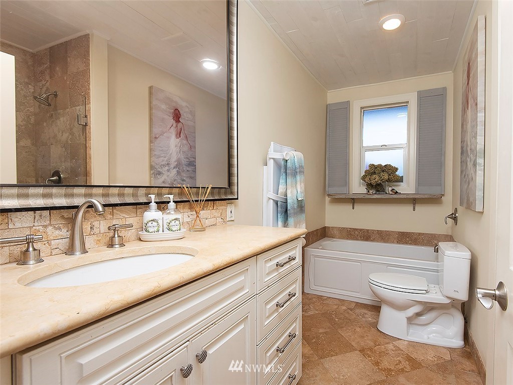 803 North 33rd Street Renton, WA 98056 - Photo 30 of 40 a bathroom with a granite countertop toilet sink and mirror
