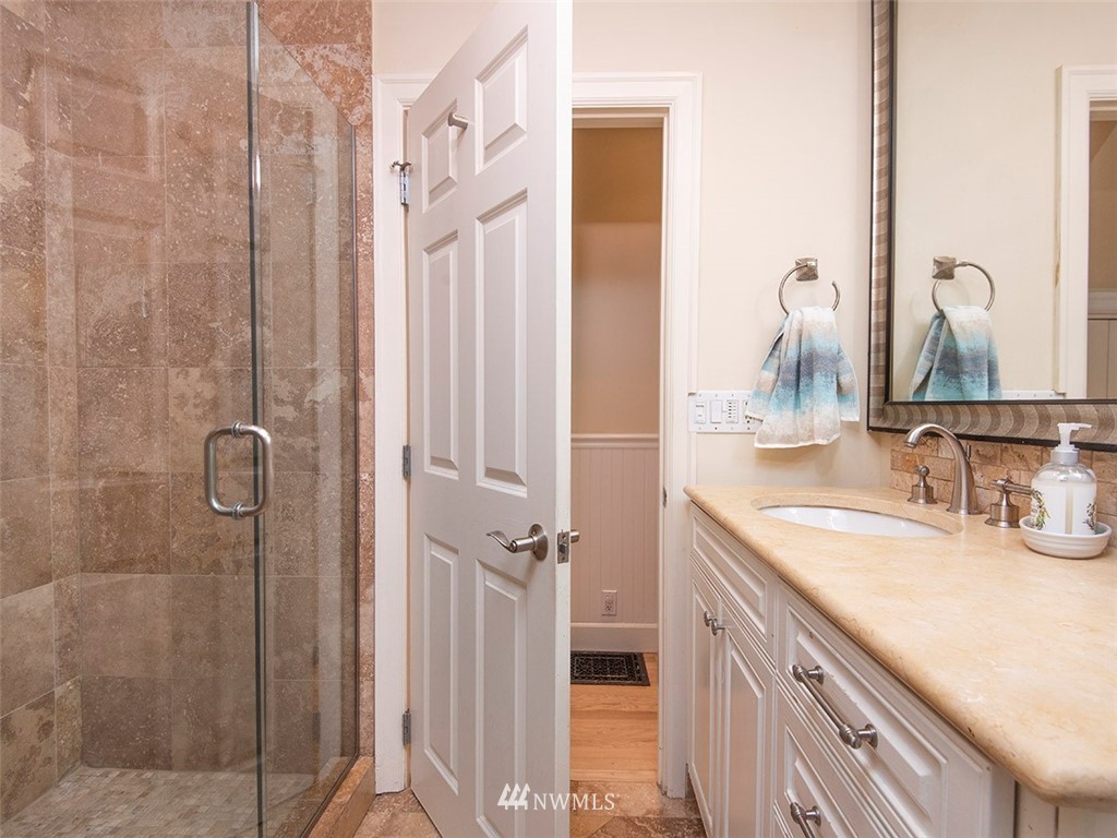803 North 33rd Street Renton, WA 98056 - Photo 31 of 40 a bathroom with a granite countertop shower sink and vanity