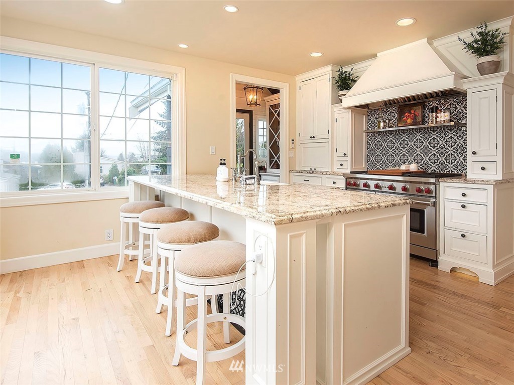 803 North 33rd Street Renton, WA 98056 - Photo 7 of 40 a kitchen with a stove a sink a dining table and chairs