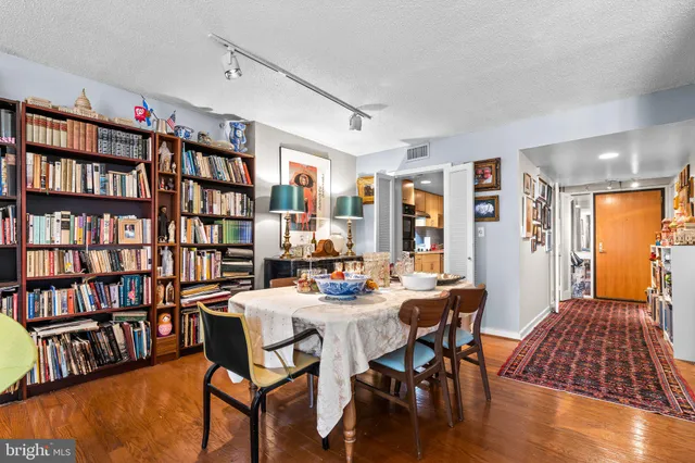a view of a livingroom with furniture and bookshelf