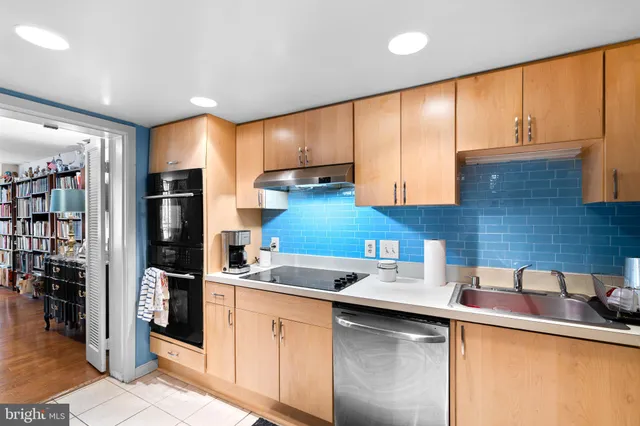 a kitchen with stainless steel appliances granite countertop a sink and cabinets
